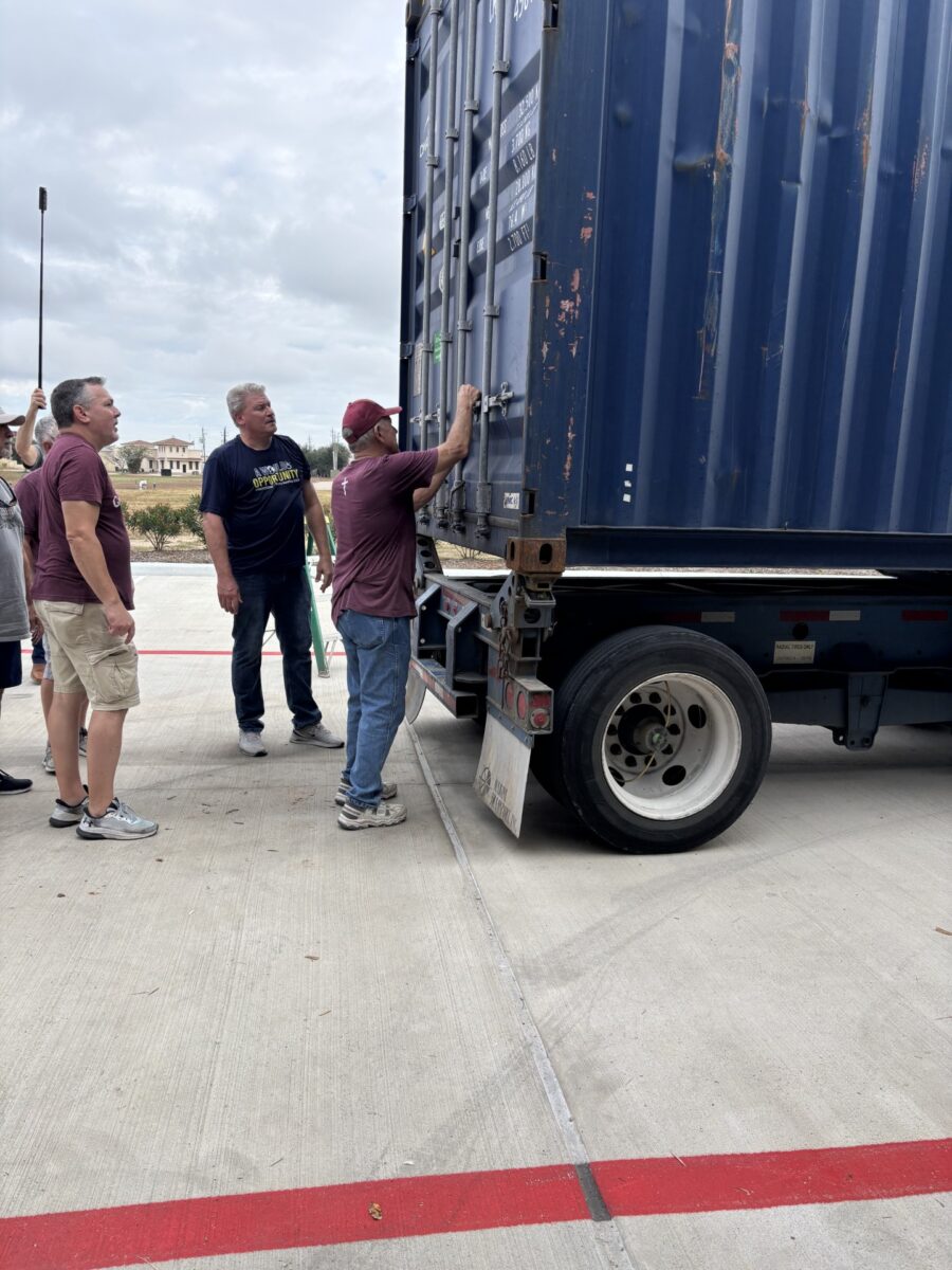 Steve Harris, David Ankenman and Mike Rathje making the final closing of the container.